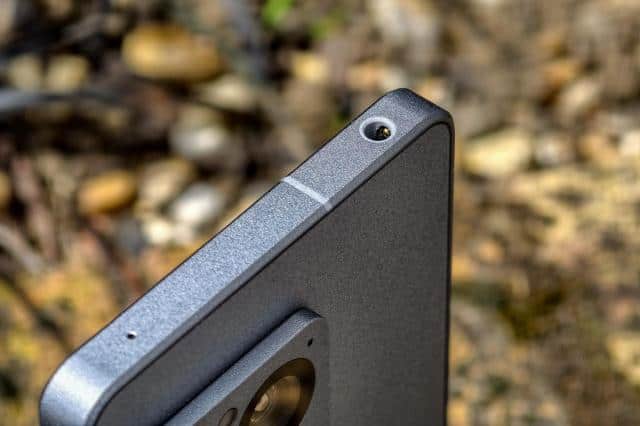 Photo of the Sony Xperia 1 VIII in front of dirt, showing the headphone jack slot