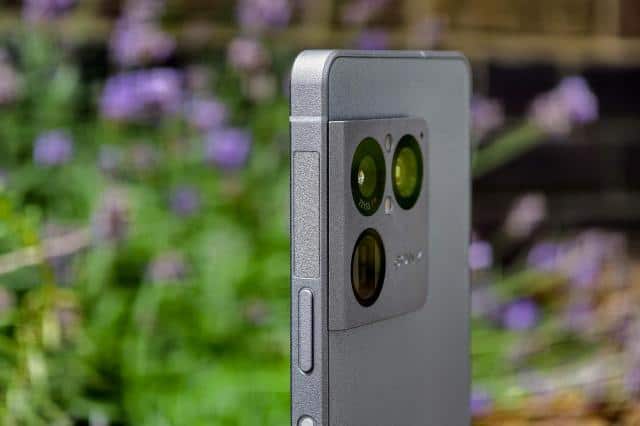 Photo of the Sony Xperia 1 VIII in front of flowers, showing the textured frame and buttons