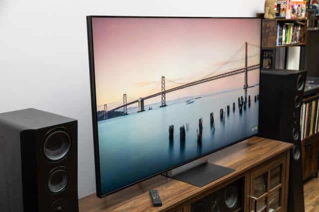 The Sony Bravia 9 II RGB LED TV on a wooden credenza with SVS speakers on either side.