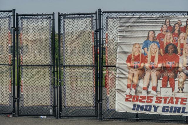 A poster of a girls’ team hangs on a fence at a field of a Loudoun County public high school.