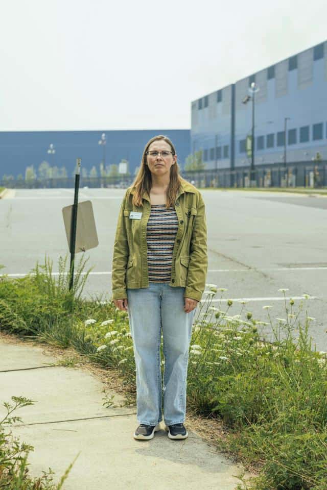 Piedmont Environmental Council land use director Julie Bolthouse stands in front of the blue Vantage VA2 data center in Ashburn, Virginia.