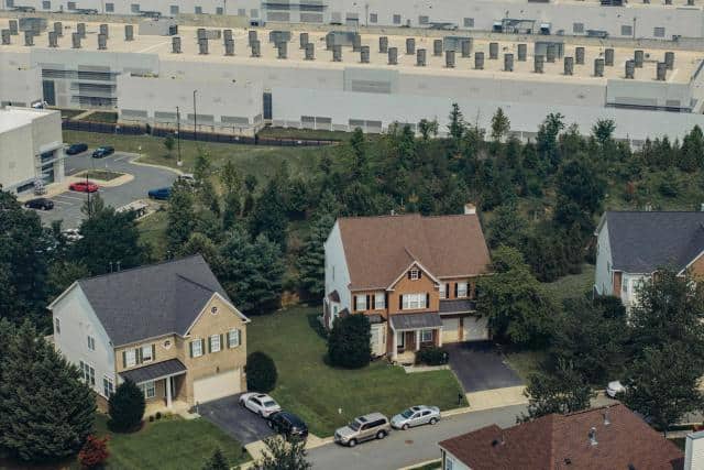 A neighborhood of nice houses in Sterling, Virginia, sits right next to a boxy and industrial-looking data center.