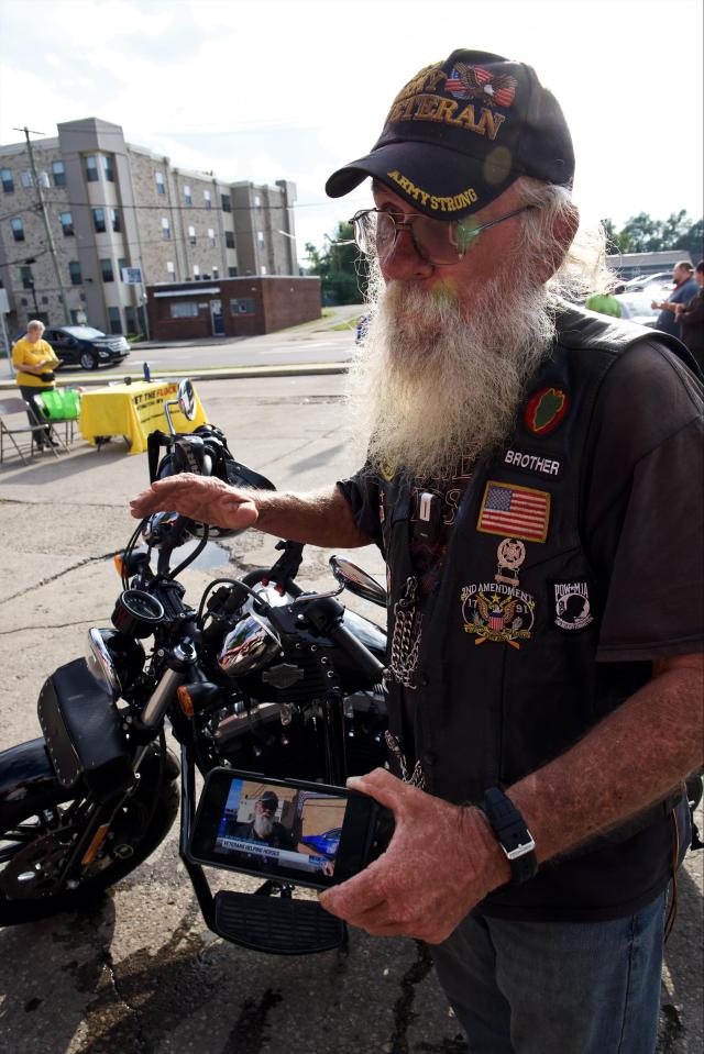 Dennis Gibson showing reporter a video done by local news crew, interviewing him about Veteran’s Helping Heroes.
