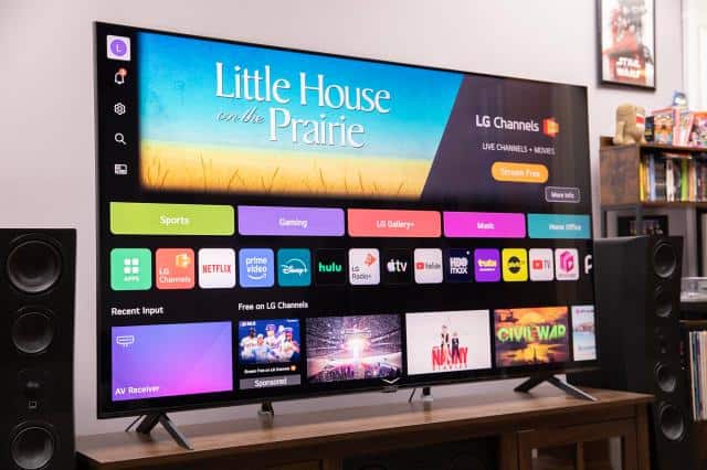 LG MRGB95B RGB LED TV on a TV stand showing a menu screen.