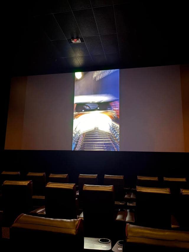 A photo of a vertical microdrama being projected on a movie theater screen.