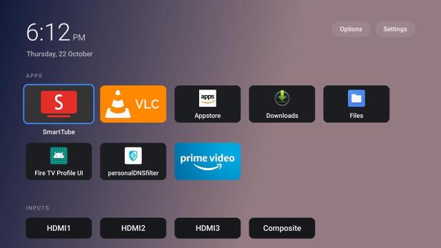 A TV operating system homescreen without ads showing app tiles and TV input connections.