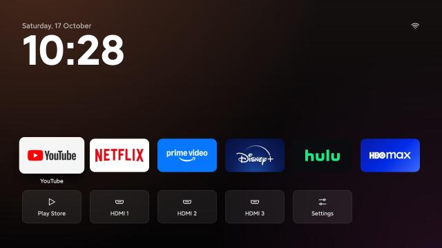 A TV operating system home page without ads and large tiles to select different streaming services and TV inputs.