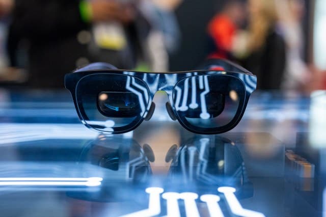 Pair of XREAL smart glasses lit up in a futuristic way.
