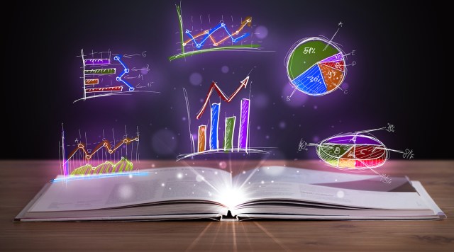 Book on wooden deck with glowing graph illustrations and symbols