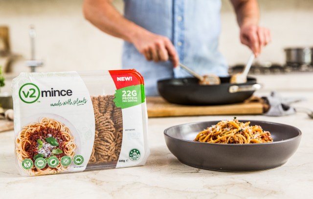 A package of v2Food's ground meat and someone cooking it in a kitchen.