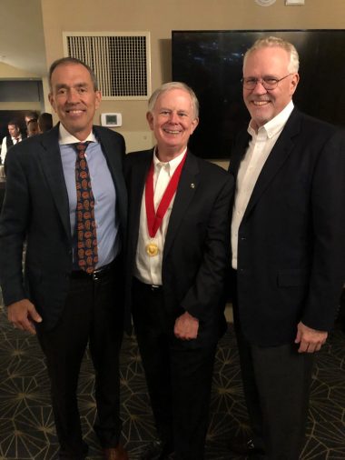 Bryce is congratulated by Bill Cutts and Ray Greer