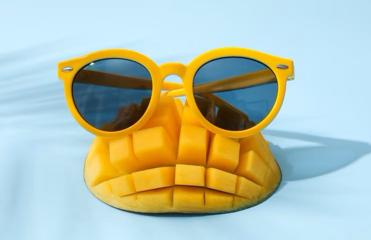 Sliced Mango With Yellow Glasses Blue Background 185193 125970