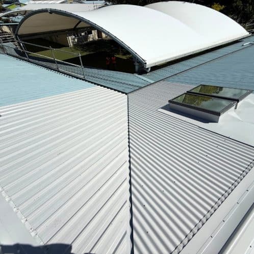 Metal roofing installation with skylights and aluminium cladding in Auckland, New Zealand. Professional roofing solutions by Keola, enhancing durability and aesthetic appeal for commercial and residential buildings.