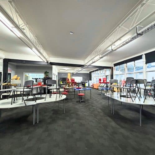 Keola commercial space with stacked chairs and tables for events or meetings in Auckland New Zealand.