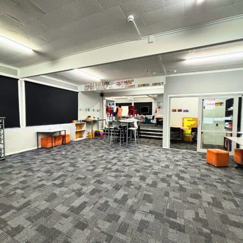 Modern classroom with blackboards, student desks, and educational resources, suitable for early childhood and primary learning environments. Bright, spacious, and well-equipped for innovative teaching.
