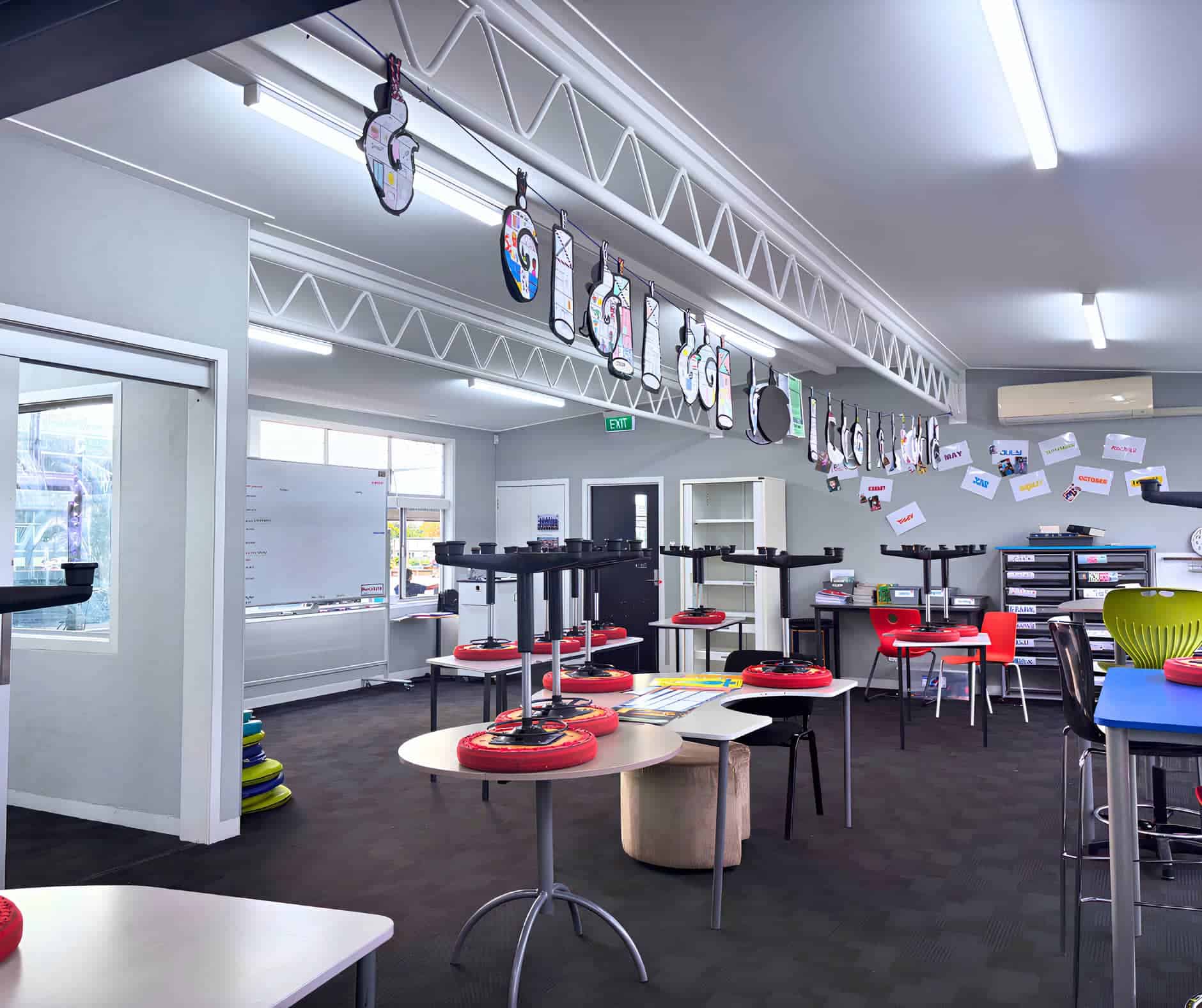 Indoor sports and recreational activity centre with table tennis equipment, colourful chairs, and sports accessories for kids and adults. Bright, modern community space for sports and leisure.