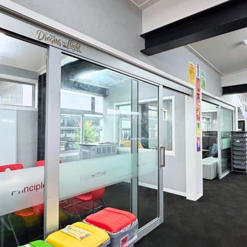 Keola interior therapy room with glass partitions and colourful chairs.