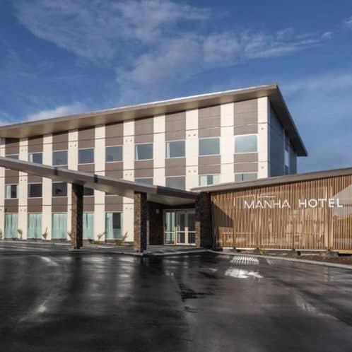 Contemporary Manha Hotel building with modern architecture in New Zealand, featuring sleek design, large windows, and welcoming entrance, ideal for comfortable accommodation and business stays.