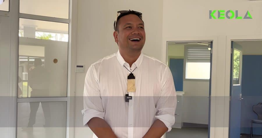 Friendly man in professional attire smiling indoors at Keola construction company New Zealand.