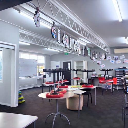 Indoor sports and recreational activity centre with table tennis equipment, colourful chairs, and sports accessories for kids and adults. Bright, modern community space for sports and leisure.