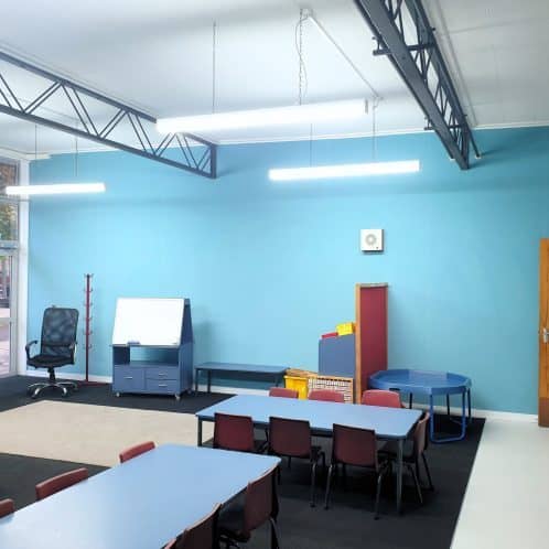 Bright and colourful classroom interior for early childhood education with tables, chairs, and educational decor in New Zealand.