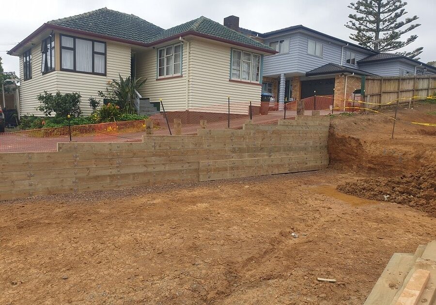 Keola is a trusted construction company based in Auckland, New Zealand, specializing in residential building projects. This image showcases their expertise in site preparation and retaining wall const.
