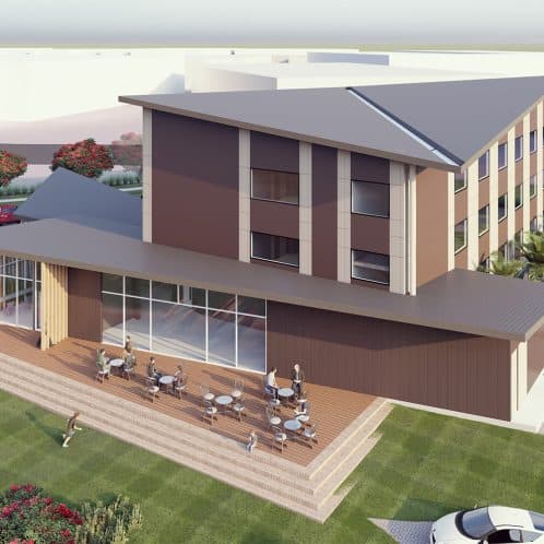 Modern multi-storey building with outdoor café area and landscaped surroundings, showcasing innovative architecture and outdoor seating in a professional environment.