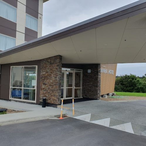 Modern hotel entrance with stone accents and contemporary design in New Zealand.