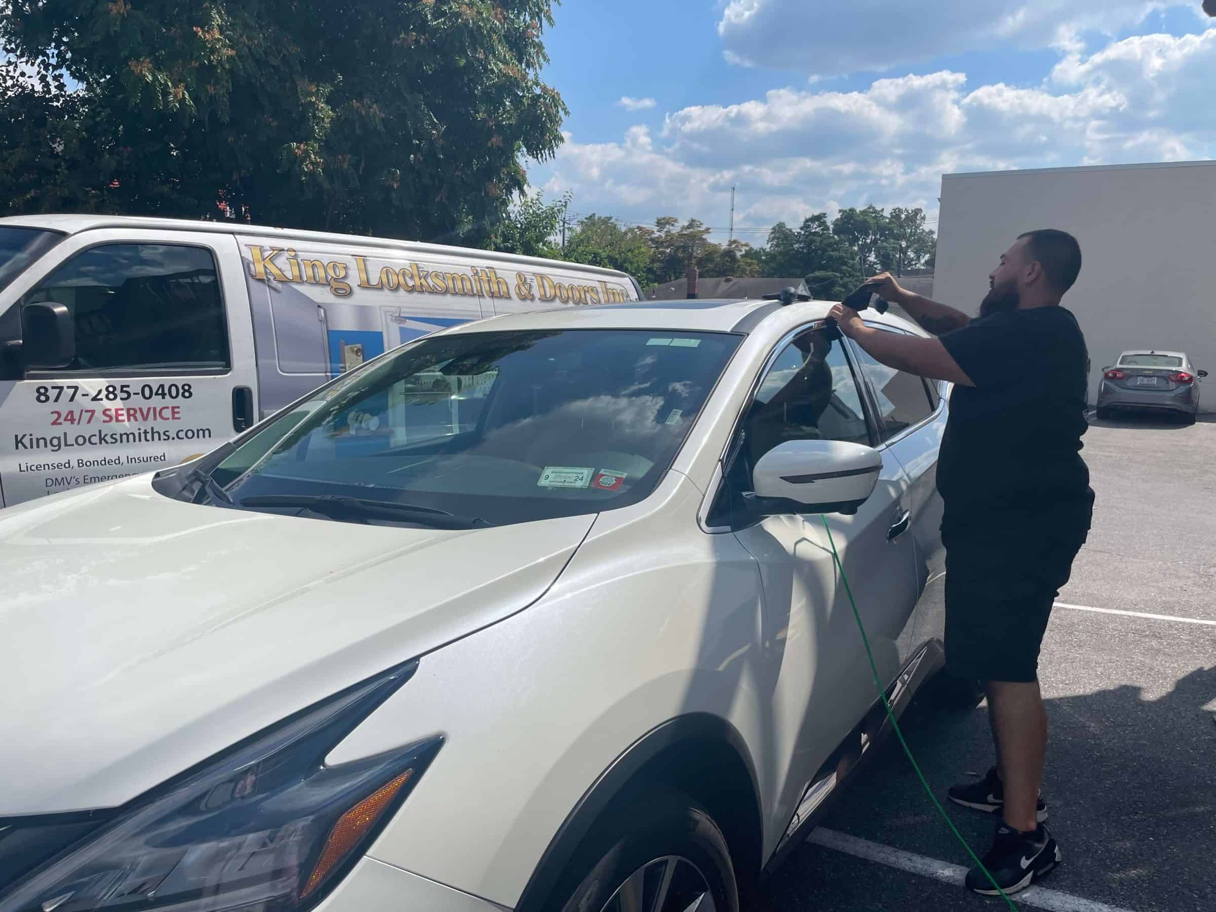 A Locksmith, In Uniform, Specializes In Car Locksmith Services For King Locksmith In Washington Dc, Repairing A White Car