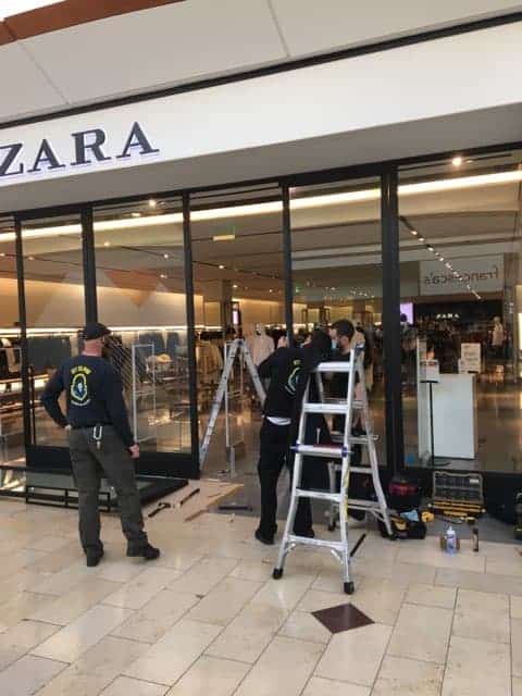 Three Dc Locksmiths In Black Uniforms Working On Steel Ladder In Commercial Building Zara
