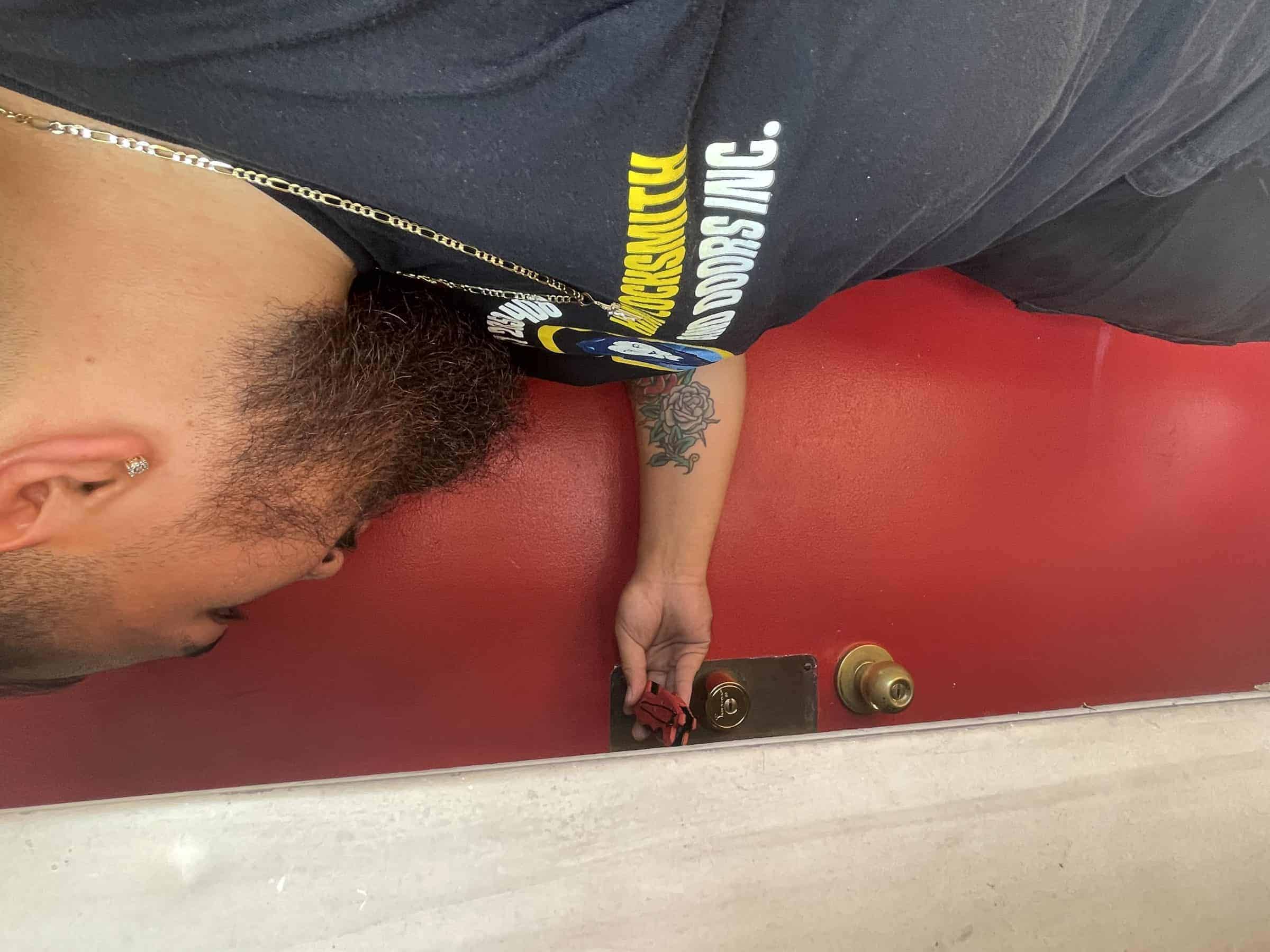 House Lockout: Locksmith In Black Uniform Checks Door Knob