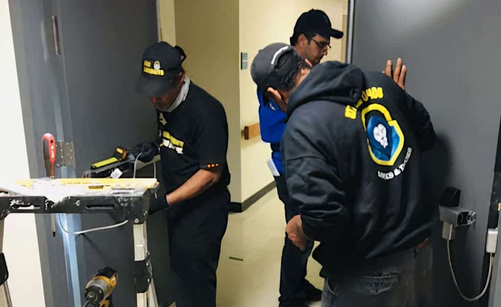 Locksmith Columbia Md Three Locksmith Columbia Md, Diligently Attending To Their Locksmithing Services.