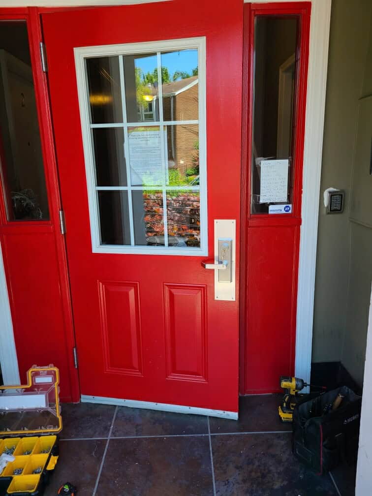 A Commercial Exterior Showcasing Red Door Recently Installed, Best For Security Doors Installation Near Me