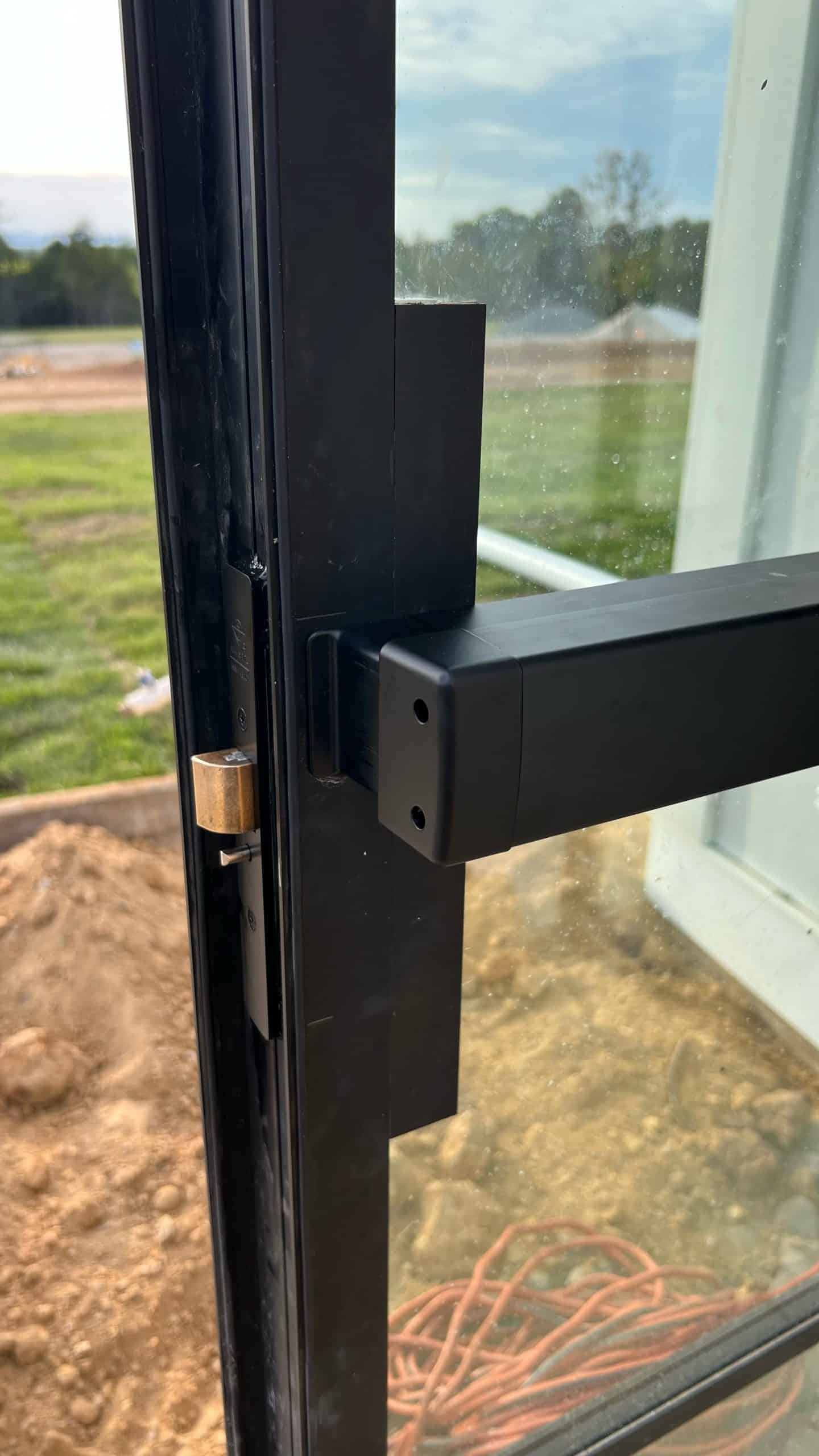 A Black Commercial Door With A Push Bar Handle, Requiring Commercial Door Lock Repair