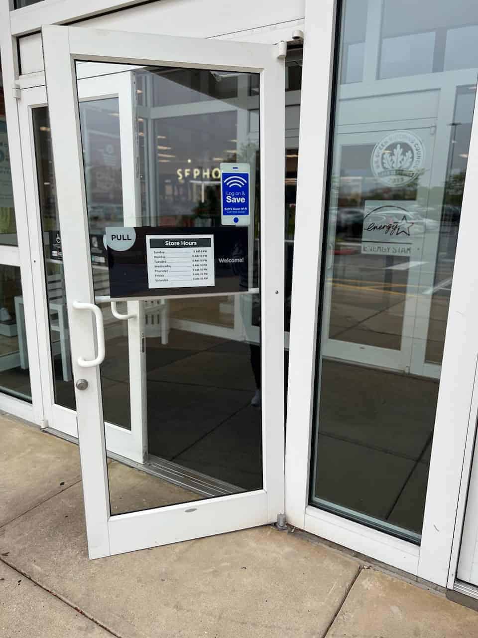 A Glass Door With White Corner Accents, Recently Installed, Depicting Commercial Locksmiths Near Me.