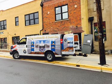 A Mobile Locksmith Van Parked Outside A Residential Area, Featuring Emergency Locksmith Services By King Locksmith.