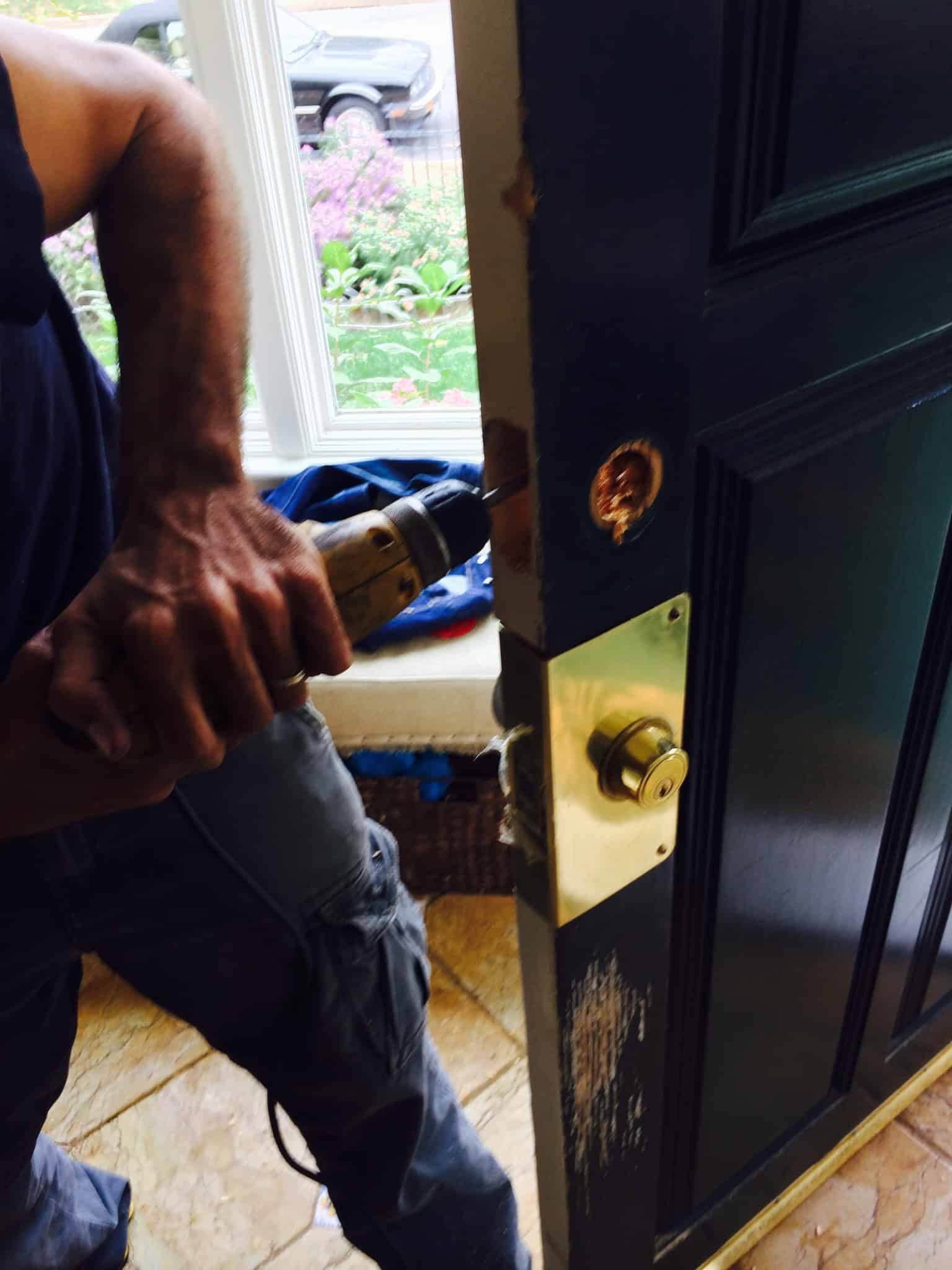 Locksmith Emergency An Image Of A Locksmith Diligently Repairing A Door Knob, Addressing A Locksmith Emergency.