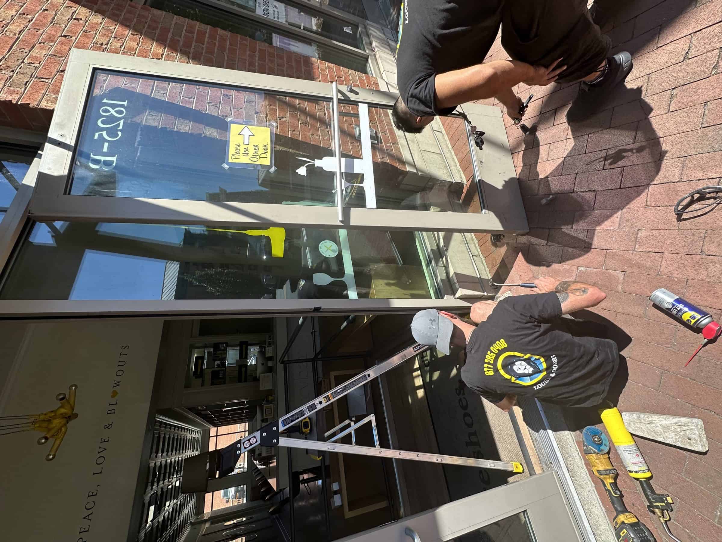 Locksmith In Frederick Md Three King Locksmiths In Frederick Md Working On A Storefront Glass Door.