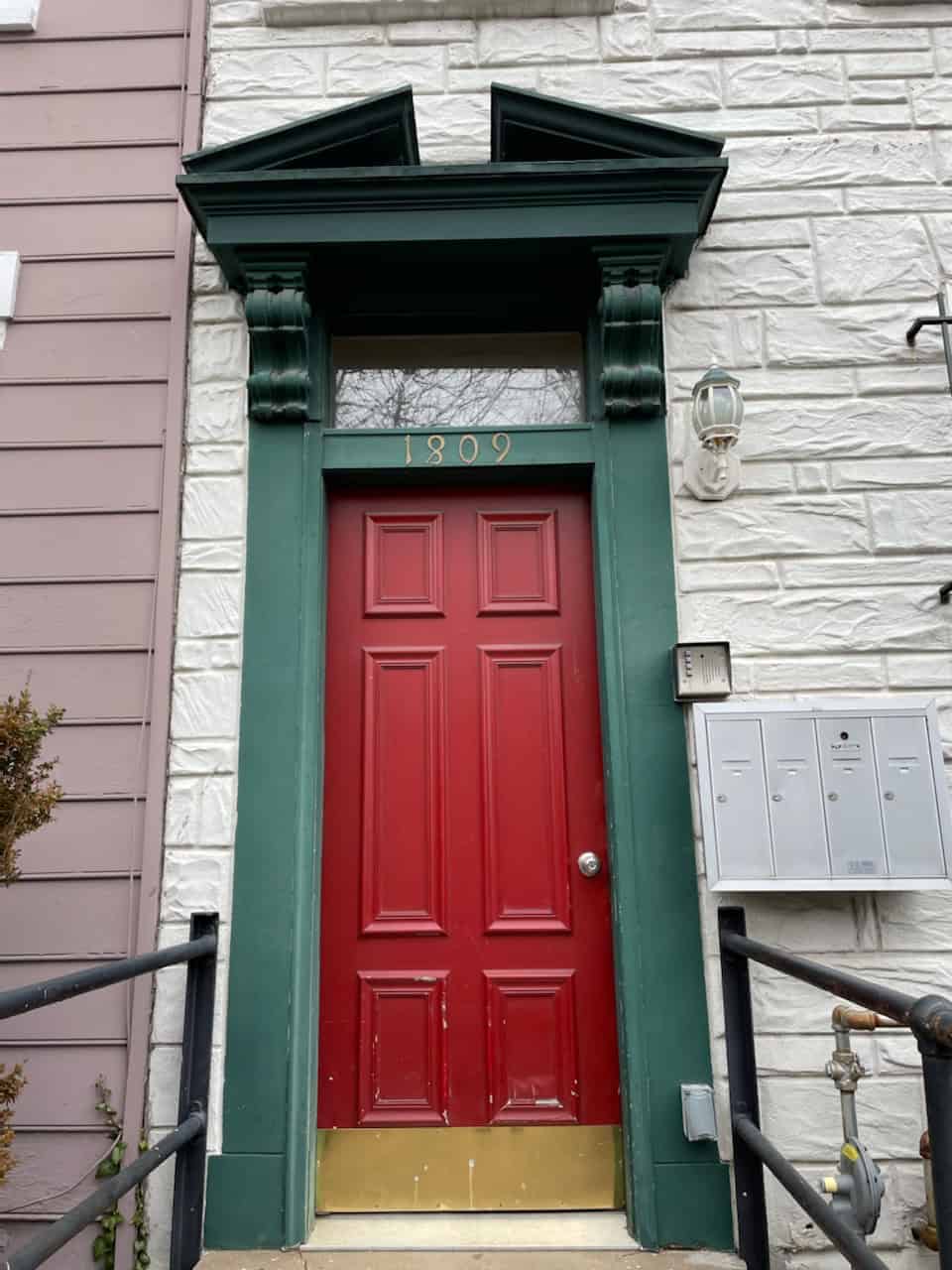 A Photo Of A Red Door With Green In The Corner Installed By Residential Locksmith In Md-Dc