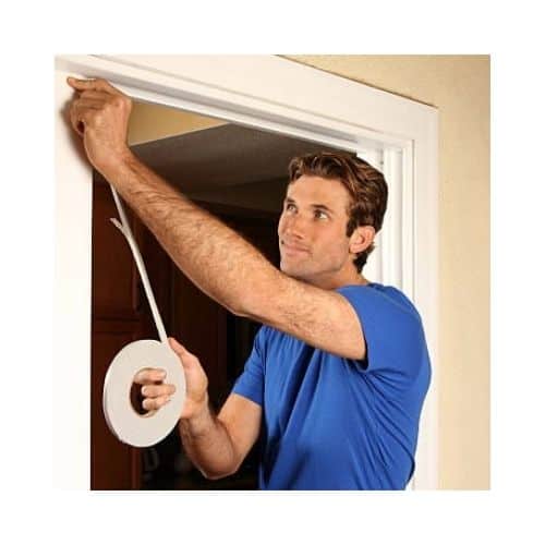 Man In A Blue Shirt Doing Weather Stripping In His Door At Burtonsville Maryland