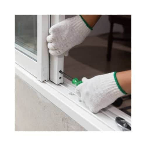 Locksmith With White Gloves Repairing The Door Roller In A Sliding Door At Olney Md