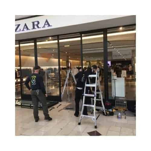 Locksmiths In Black Repairing The Storefront Door In Catonsville Md