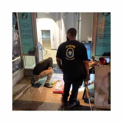 Aluminum Door Repair In Catonsville Md Two King Locksmith Staff Members Wearing Black Uniforms In Md And Dc, Repairing An Aluminum Door In Catonsville