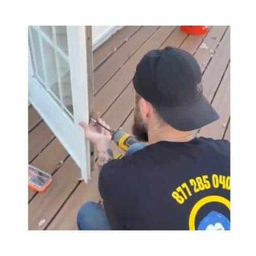 A Locksmith From King Locksmith And Doors Inc. Repairing A Patio Door In Catonsville, Md.