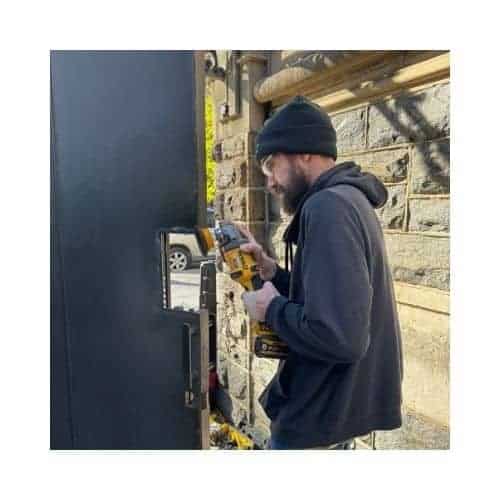Steel Door Repair In Chevy Chase Md A Locksmith Installing A Steel Door, Grinding Parts To Prepare For The Door Latch Installation In Chevy Chase