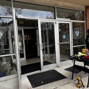 Commercial Locksmith Services In Georgetown Displayed With A Focus On Repairing Or Installing Locks On Glass Double Doors