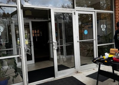 Commercial Locksmith Services In Georgetown Displayed With A Focus On Repairing Or Installing Locks On Glass Double Doors