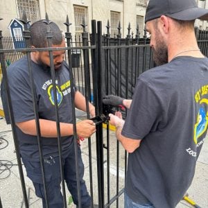 Anne Arundel County Maryland Locksmith Services Commercial Locksmith Anne Arundel Fixing A Gate Lock With Tools In A Collaborative Setup. Commercial Locksmith Anne Arundel Fixing A Gate Lock With Tools In A Collaborative Setup.