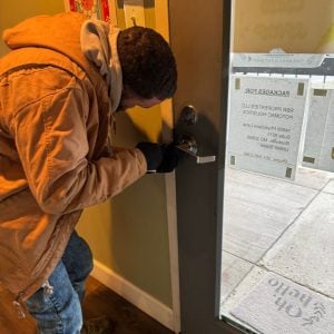 Commercial Locksmith In Elkridge Working On A Business Door Lock, Providing Expert Solutions For Reliable Access And Security