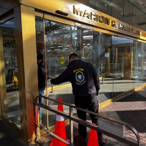Fort Meade Md Locksmith Services A Locksmith Inspecting A Glass Storefront Door For Commercial Lock Repair And Security Enhancements In Fort Meade, Md. A Locksmith Inspecting A Glass Storefront Door For Commercial Lock Repair And Security Enhancements In Fort Meade, Md.